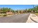 Community entrance with a 'Casa Rosa' sign, elegant gates, and manicured landscaping at 11625 Cabo Del Verde Ave, Las Vegas, NV 89138
