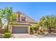 Inviting two-story home with lush landscaping, two-car garage, and quaint desert accents at 11625 Cabo Del Verde Ave, Las Vegas, NV 89138