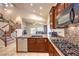 Gourmet kitchen featuring granite countertops, tile backsplash, stainless steel appliances, and gas cooktop at 11625 Cabo Del Verde Ave, Las Vegas, NV 89138
