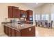 Modern kitchen with dark wood cabinets, granite countertops, and stainless steel appliances at 11625 Cabo Del Verde Ave, Las Vegas, NV 89138