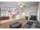 Spacious living room adjacent to the kitchen, showcasing a cozy fireplace and staircase to the second floor at 11625 Cabo Del Verde Ave, Las Vegas, NV 89138