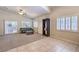 Expansive living area with carpet, plantation shutters, and stylish dark display shelving at 11625 Cabo Del Verde Ave, Las Vegas, NV 89138