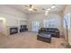Bright and airy living room featuring a cozy fireplace and large leather couch with ottoman at 11625 Cabo Del Verde Ave, Las Vegas, NV 89138