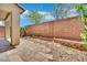 Backyard with custom stone patio, privacy wall and space for landscaping at 11787 Fern Creek Ln, Las Vegas, NV 89183