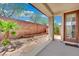 Cozy backyard patio with seating area and mature palm tree at 11787 Fern Creek Ln, Las Vegas, NV 89183