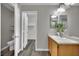 The bathroom is well-lit, with double mirrors, a sink, and wood floors at 11787 Fern Creek Ln, Las Vegas, NV 89183