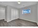 This bedroom features wood-look floors, a double closet, and a window with a view at 11787 Fern Creek Ln, Las Vegas, NV 89183