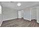 Bedroom featuring wood-look floors, neutral walls, and a walk-in closet at 11787 Fern Creek Ln, Las Vegas, NV 89183