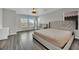 Large bedroom with neutral walls, wood-look flooring, and bright natural light at 11787 Fern Creek Ln, Las Vegas, NV 89183