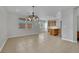 Bright dining area and kitchen with tile floors, wooden cabinets, and pendant lighting at 11787 Fern Creek Ln, Las Vegas, NV 89183