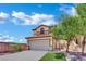 Charming two-story home with a tan exterior, tile roof, and an attached two-car garage at 11787 Fern Creek Ln, Las Vegas, NV 89183