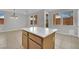 Spacious kitchen island with white countertops and wood cabinets at 11787 Fern Creek Ln, Las Vegas, NV 89183
