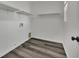 Cozy laundry room with built-in shelving and wood-look flooring at 11787 Fern Creek Ln, Las Vegas, NV 89183