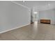 Open-concept living room features tile floors, neutral paint, and ample natural light at 11787 Fern Creek Ln, Las Vegas, NV 89183