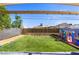 Lush backyard features a well-maintained lawn and play area, great for Gathering fun at 123 Cedar St, Henderson, NV 89015