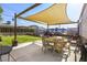 Spacious backyard with a covered patio, ideal for outdoor dining and relaxation at 123 Cedar St, Henderson, NV 89015