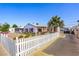 Quaint house exterior featuring a white picket fence and low maintenance yard at 123 Cedar St, Henderson, NV 89015