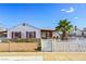 Charming single-story home featuring a white picket fence and well-maintained landscaping at 123 Cedar St, Henderson, NV 89015