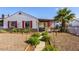 Inviting home exterior with lush landscaping, a cozy porch and rock ground cover at 123 Cedar St, Henderson, NV 89015