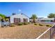 Charming home exterior with low maintenance landscaping and a white picket fence at 123 Cedar St, Henderson, NV 89015