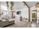 Open-concept living room featuring a sectional sofa, TV, and dining area with access to the bathroom at 123 Cedar St, Henderson, NV 89015