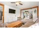 Cozy living room with modern furnishings, a large TV, wood accents, and access to other rooms at 123 Cedar St, Henderson, NV 89015