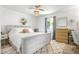 Serene main bedroom with a large bed, natural light, a ceiling fan, and modern decor at 123 Cedar St, Henderson, NV 89015