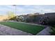 A view of the backyard area showing the putting green, brick pavers, and landscaping, creating a serene outdoor space at 12565 Huckleberry Oak Ave, Las Vegas, NV 89138