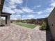 A cozy backyard with colorful flowerbeds, artificial grass and a putting green at 12565 Huckleberry Oak Ave, Las Vegas, NV 89138