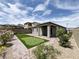 Backyard with putting green, patio, and view of neighboring homes and mountains at 12565 Huckleberry Oak Ave, Las Vegas, NV 89138