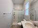 Bathroom featuring a shower with glass door, toilet, and sink at 12565 Huckleberry Oak Ave, Las Vegas, NV 89138