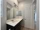 Modern bathroom with a large mirror, a sink, and white cabinets at 12565 Huckleberry Oak Ave, Las Vegas, NV 89138