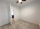 Cozy bedroom featuring plush carpeting, neutral walls, and an open door with views of the kitchen at 12565 Huckleberry Oak Ave, Las Vegas, NV 89138