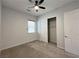 Bedroom with carpeted floors, ceiling fan, and a closet with wire shelving at 12565 Huckleberry Oak Ave, Las Vegas, NV 89138