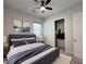 Comfortable bedroom featuring a ceiling fan, closet, and modern decor at 12565 Huckleberry Oak Ave, Las Vegas, NV 89138