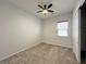 Bedroom featuring a ceiling fan, window, neutral carpet and an open closet at 12565 Huckleberry Oak Ave, Las Vegas, NV 89138