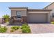 Beautiful exterior with stone accents, a two-car garage, and a well-maintained front yard at 12565 Huckleberry Oak Ave, Las Vegas, NV 89138