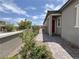 Charming walkway leading to the front door, with brick pavers and lush landscaping, enhancing curb appeal and creating a welcoming entrance at 12565 Huckleberry Oak Ave, Las Vegas, NV 89138