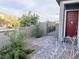 Landscaped front yard with decorative plants, a secure gate, and a paved walkway leading to the front door at 12565 Huckleberry Oak Ave, Las Vegas, NV 89138