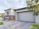 Two-car garage with brick paved driveway at 12565 Huckleberry Oak Ave, Las Vegas, NV 89138