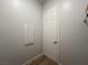 A hallway featuring neutral flooring, a white door, and electrical panel at 12565 Huckleberry Oak Ave, Las Vegas, NV 89138