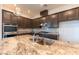 Kitchen island featuring a sink and faucet, granite countertop, and stainless steel appliances at 12565 Huckleberry Oak Ave, Las Vegas, NV 89138