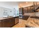 Modern kitchen with stainless steel appliances, granite countertops, an island with breakfast bar, and hardwood floors at 12565 Huckleberry Oak Ave, Las Vegas, NV 89138
