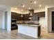 Modern kitchen featuring granite counters, stainless steel appliances, stylish cabinets, and a center island with pendant lighting at 12565 Huckleberry Oak Ave, Las Vegas, NV 89138