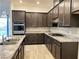 Gourmet kitchen boasts granite countertops, stainless steel appliances, and dark wood cabinets with ample storage space at 12565 Huckleberry Oak Ave, Las Vegas, NV 89138