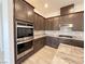 Well-equipped kitchen features stainless steel appliances, granite countertops, stylish backsplash, and dark cabinets at 12565 Huckleberry Oak Ave, Las Vegas, NV 89138