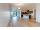 Open-concept living room with wood floors, modern lighting, and seamless transition to the kitchen at 12565 Huckleberry Oak Ave, Las Vegas, NV 89138