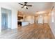 Spacious living room with wood floors, modern lighting, and open layout to the kitchen at 12565 Huckleberry Oak Ave, Las Vegas, NV 89138