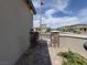 Side yard entrance featuring a secure gate and decorative stone pillars at 12565 Huckleberry Oak Ave, Las Vegas, NV 89138