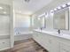 This bathroom is bright, has a luxury tub, double sinks, and a standing shower at 1351 Huckleberry St, Pahrump, NV 89048